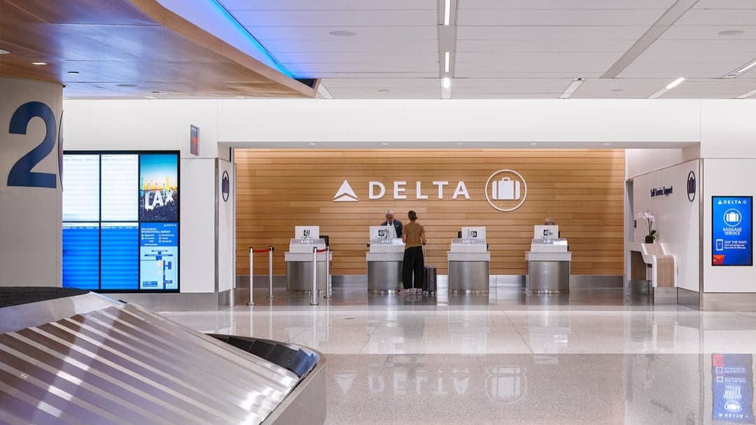 Delta check-in desks beneath branded wall signage