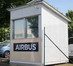 A single-storey gatehouse carrying the Airbus wordmark across its side wall.