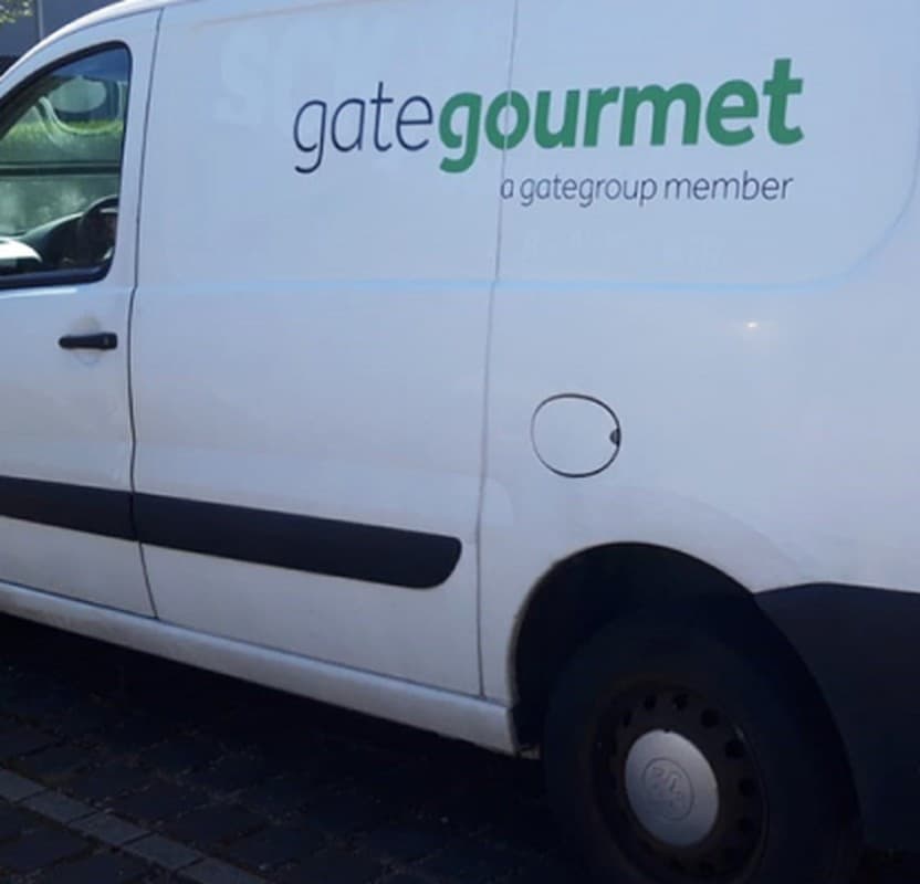 A Gate Gourmet-branded van with the wordmark on its side panel.