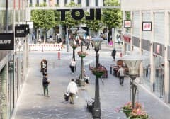 Shoppers on one of ILOT's pedestrian streets in daylight.