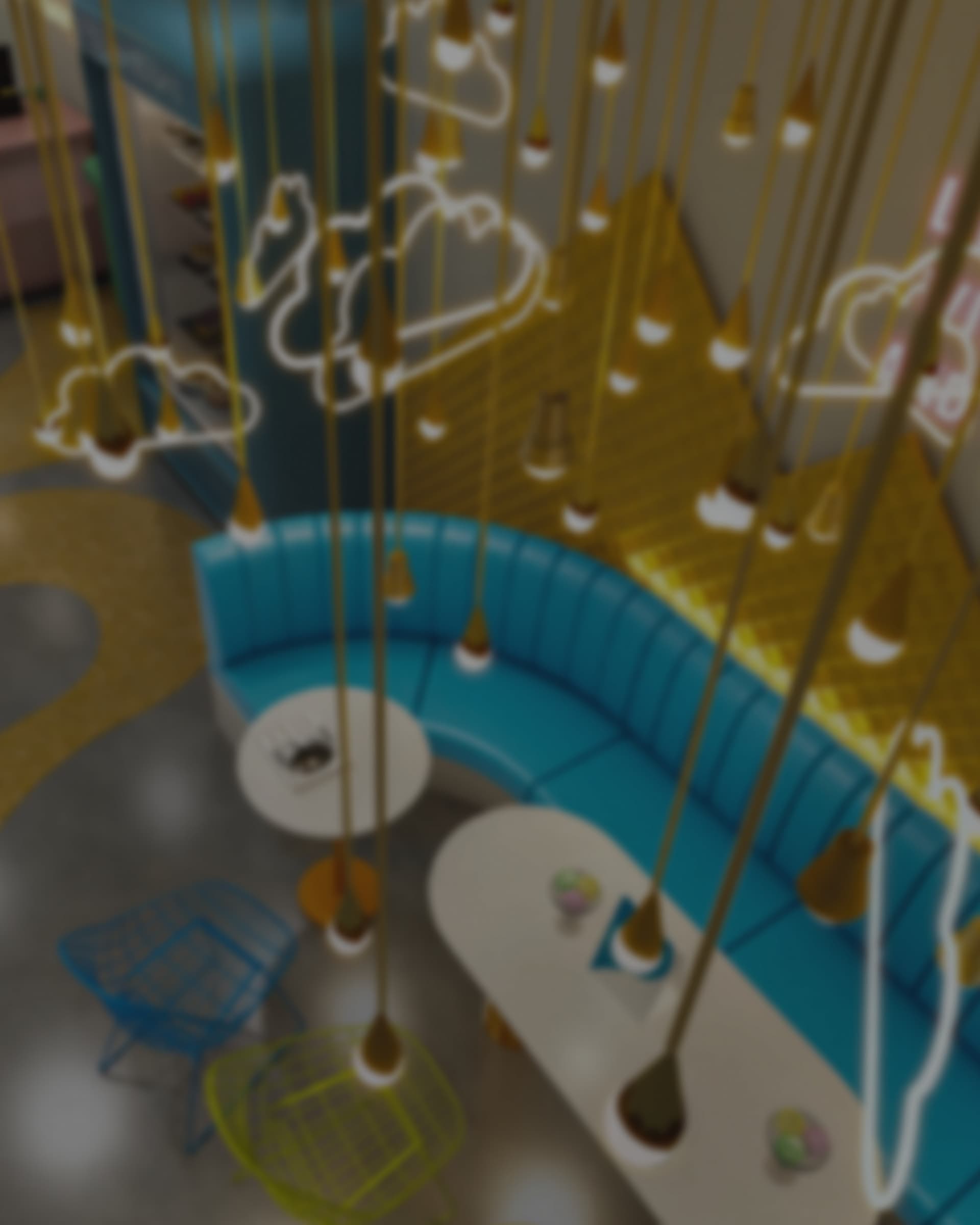 A visualisation of the Cream Bell parlour, ice-cream-cone pendant lights hanging over a curved teal booth, cloud and heart neon outlines on the wall behind.