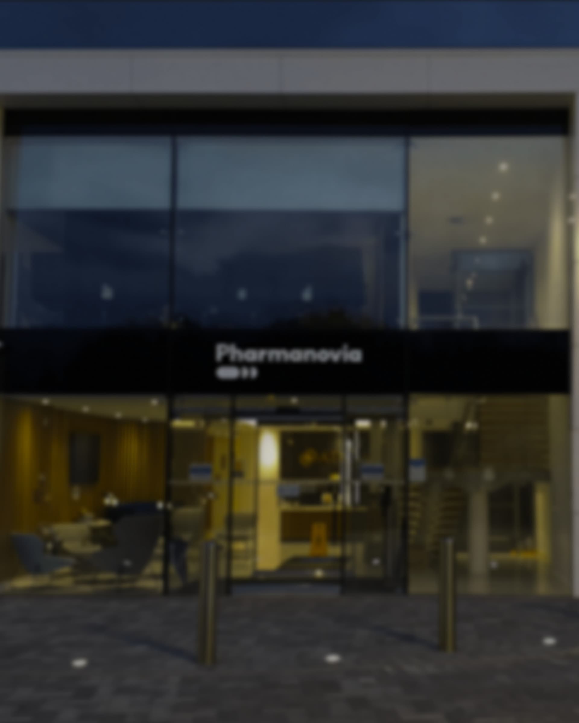 The Pharmanovia name on the fascia above the head office entrance at dusk.