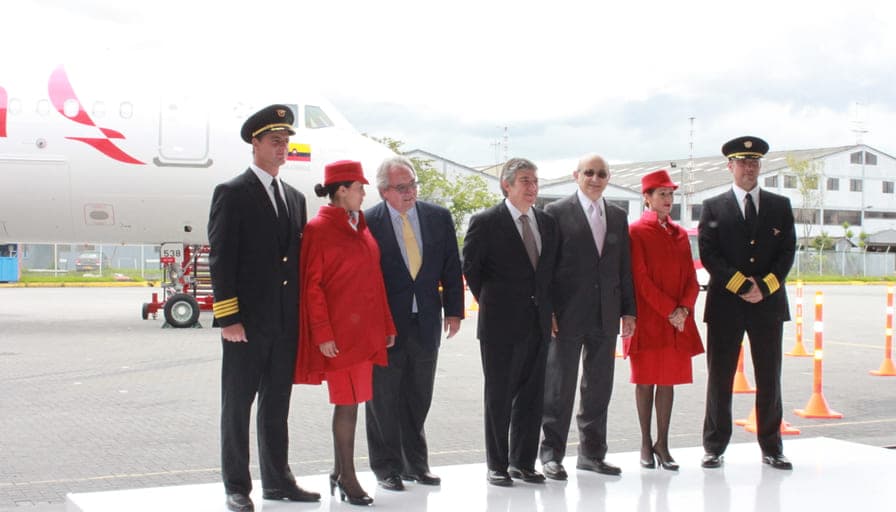 Avianca crew and executives standing together in front of a rebranded aircraft on launch day.