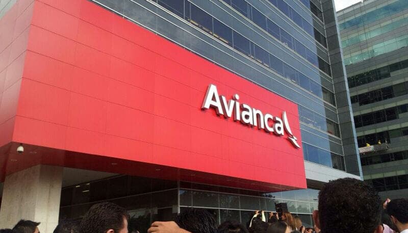 The red Avianca frontage of an airport building, a crowd gathered outside at the launch.