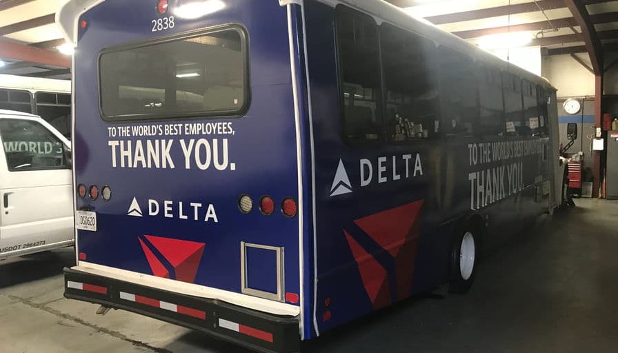 The rear of a Delta airport shuttle bus in the “To the world's best employees, thank you” livery.