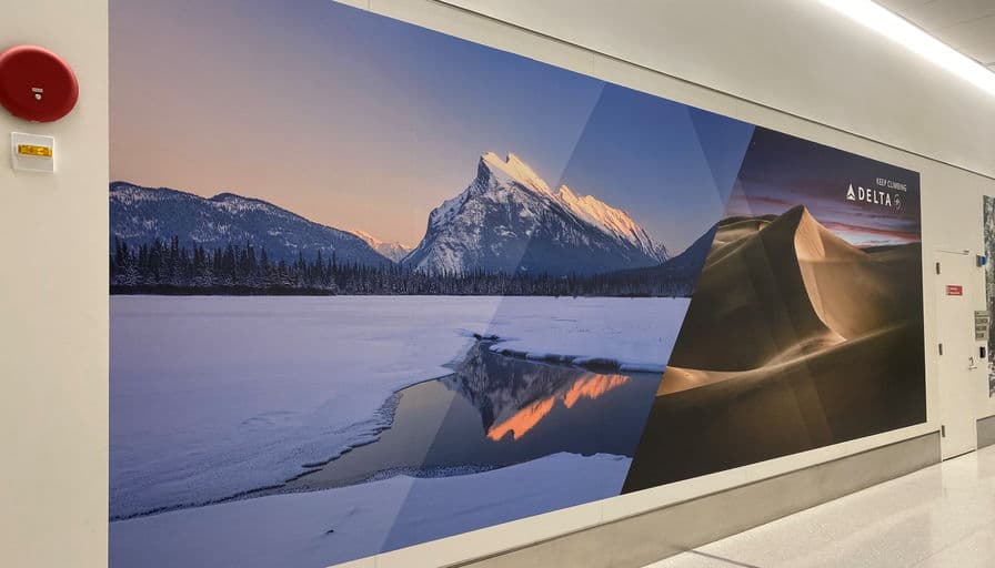 A landscape mural running the length of a Delta terminal corridor.