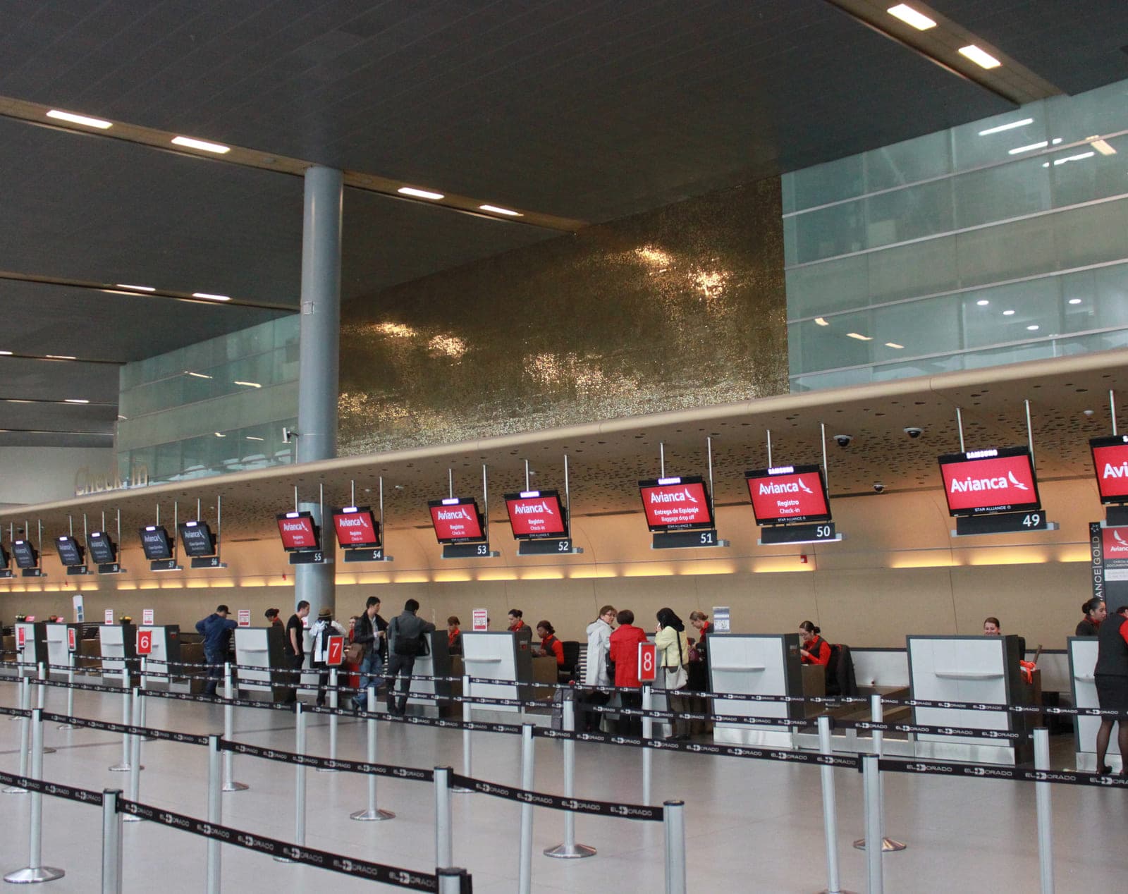 A row of Avianca check-in desks in an airport terminal, every position carrying the new identity.