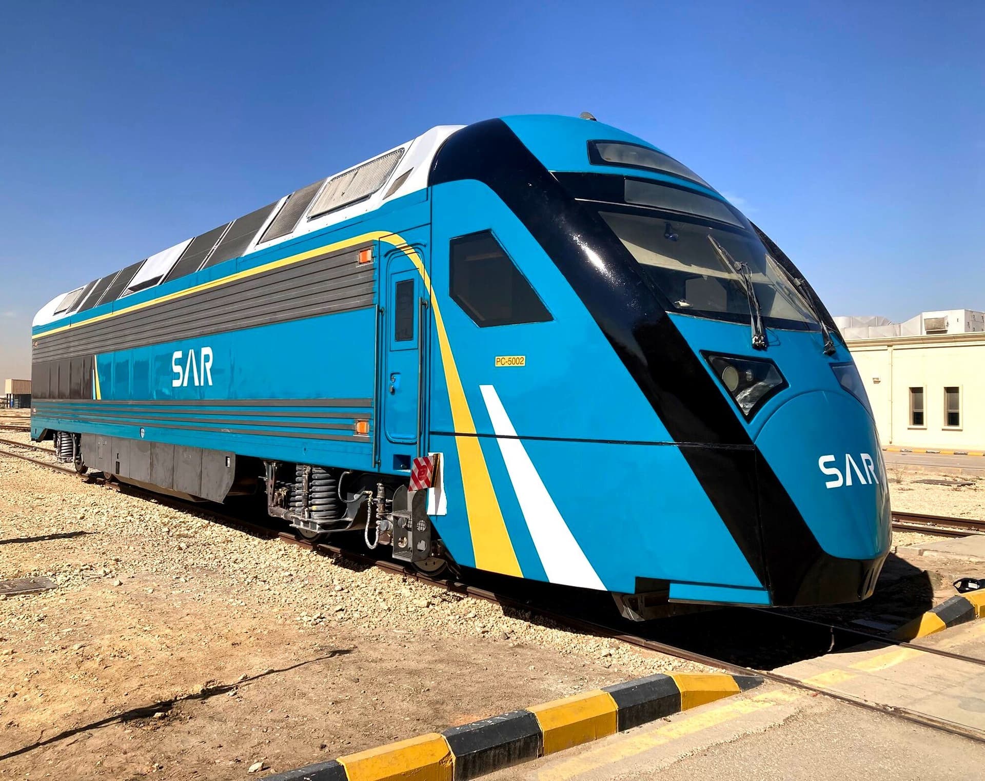 A close three-quarter view of the SAR power car's nose, showing the triple-layer protective film livery.