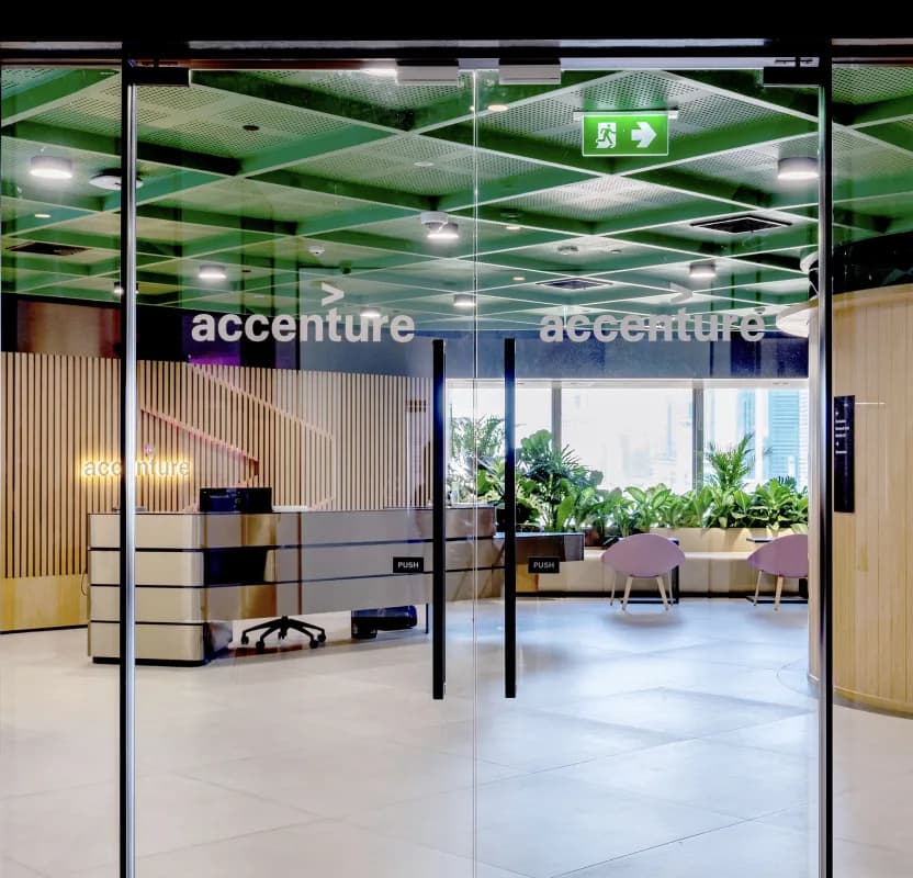 Accenture wordmarks etched across the glazed entrance to an office floor