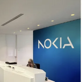A Nokia wordmark mounted on a deep blue reception wall