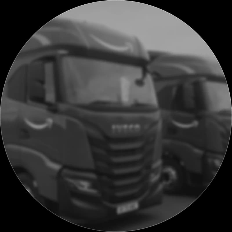 Branded articulated trucks parked side by side in a depot