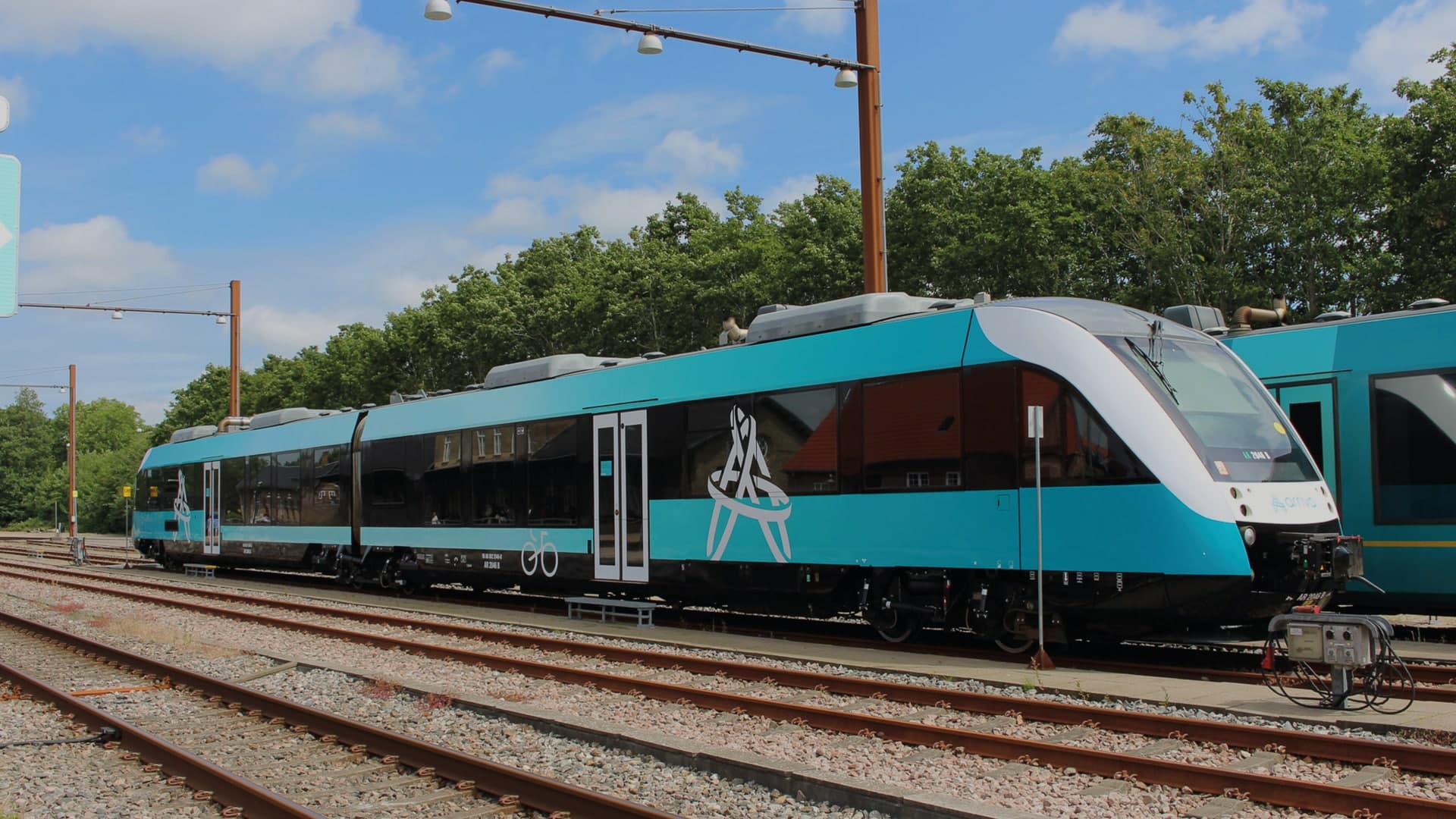 Arriva regional train in teal livery standing at a station platform