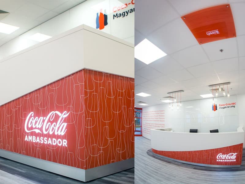 Coca-Cola Ambassador branding wrapping a reception desk and wall in the Coca-Cola HBC Hungary office