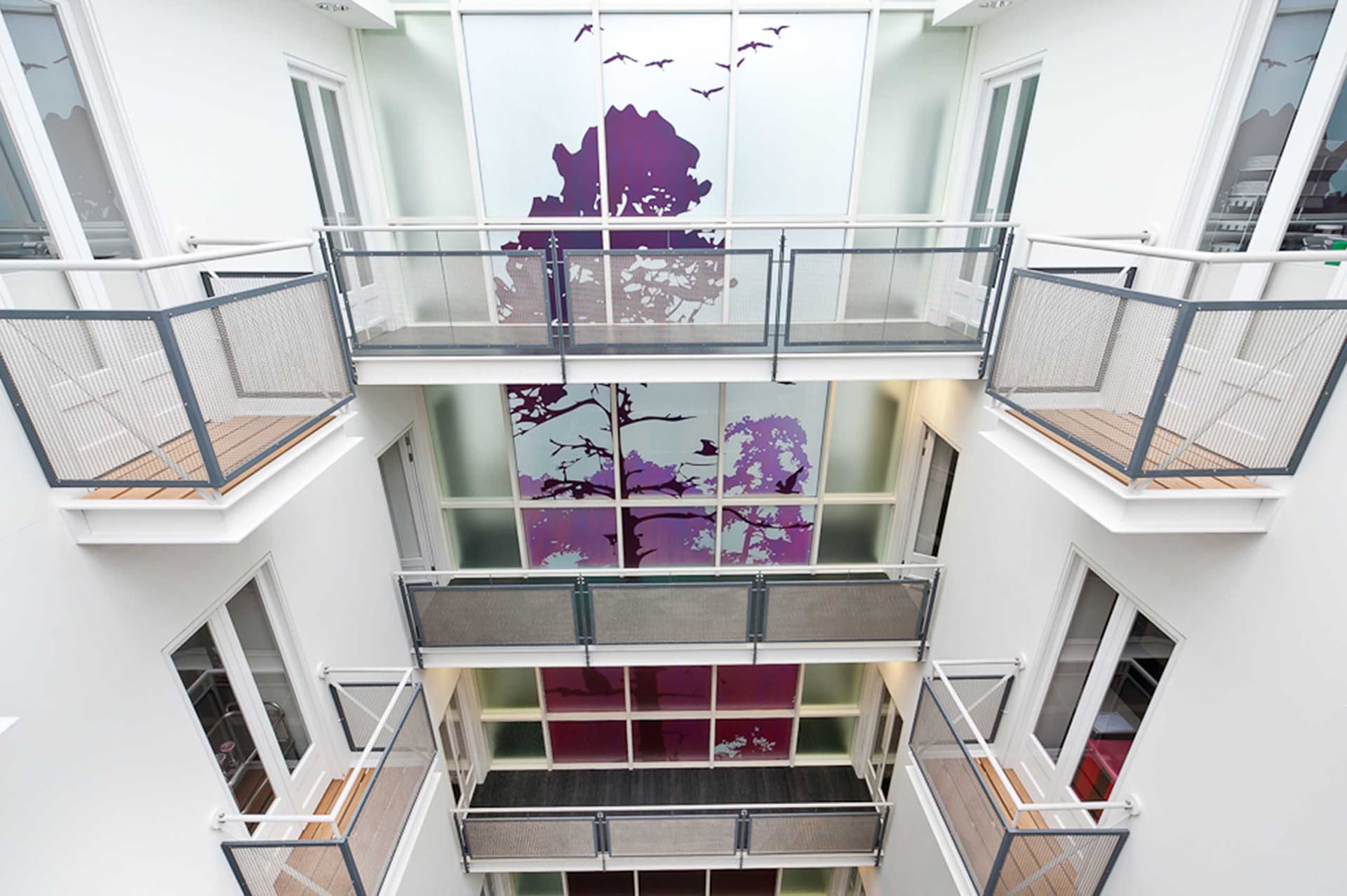 HSBC office atrium with purple tree graphics applied to the full-height glazing