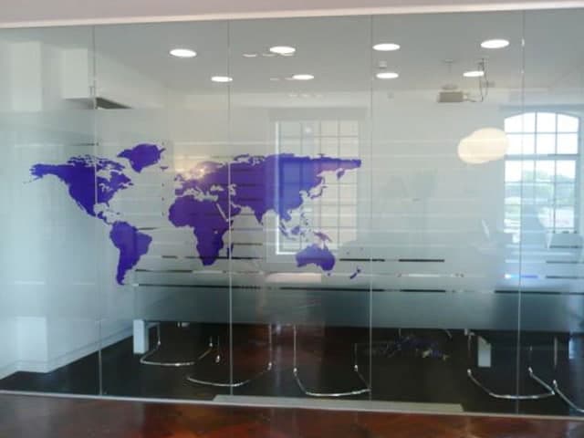 Meeting room glazing with a purple world map manifestation applied to it