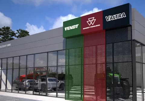 A dealership facade with stacked Fendt, Massey Ferguson and Valtra brand panels