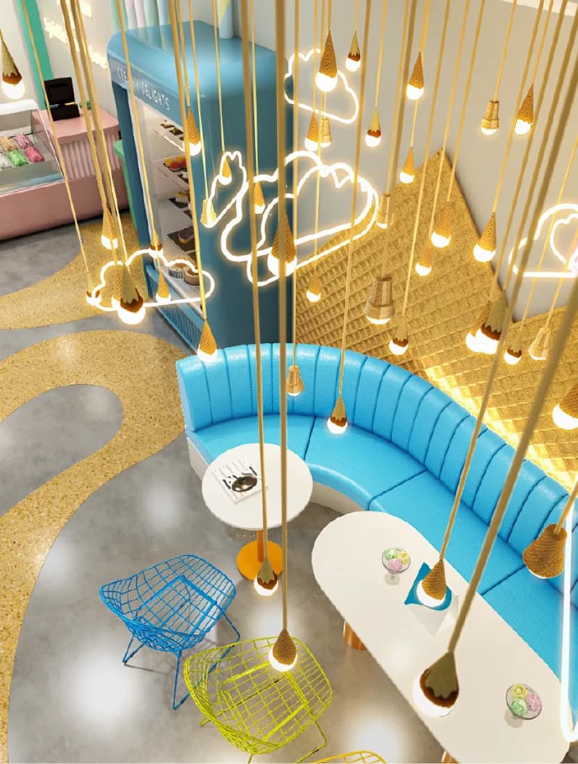 An ice cream parlour interior with gold pendant lights hanging over a curved blue banquette